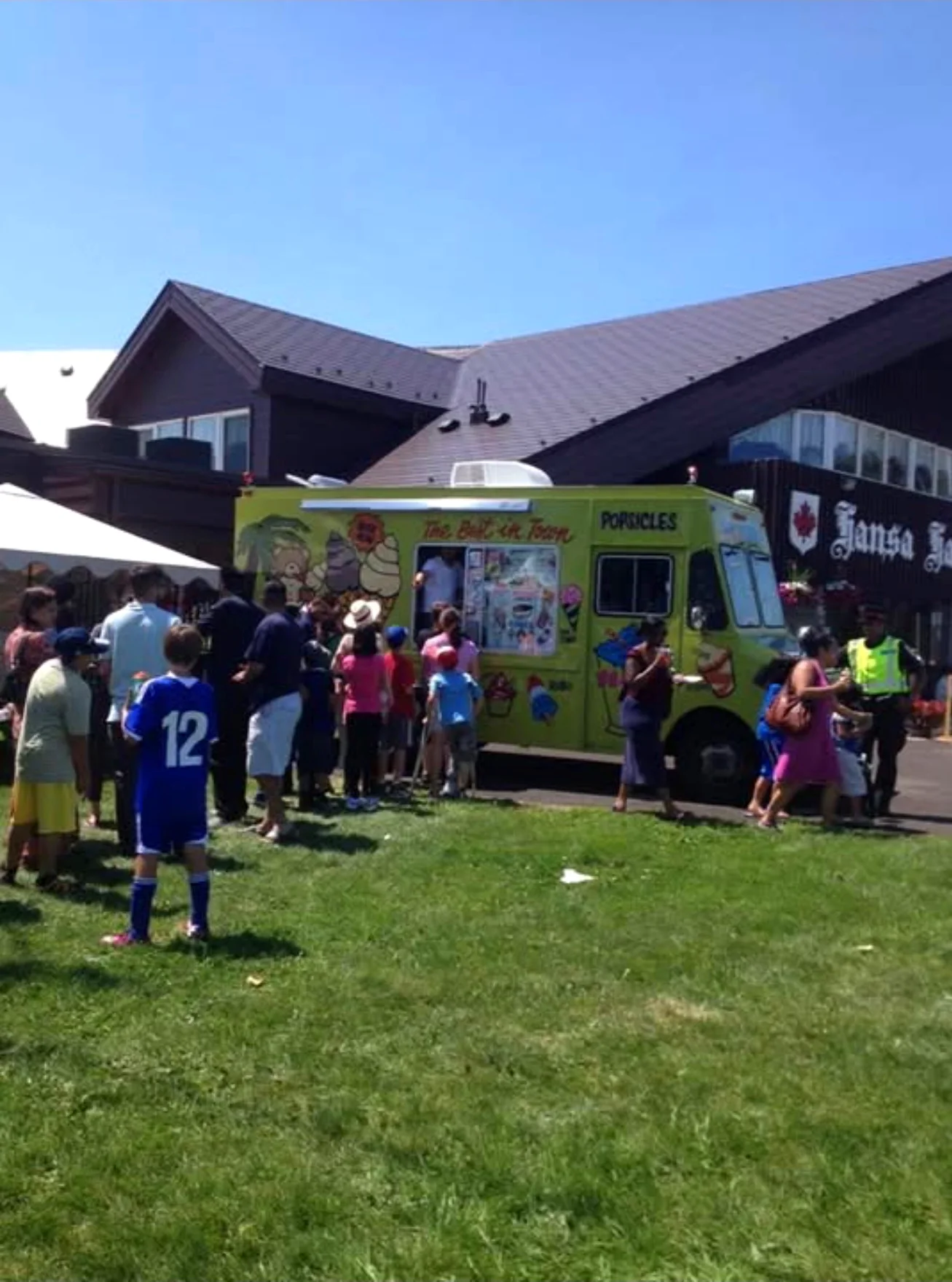 Crowd lined up at the Champion Ice Cream truck at a community event
