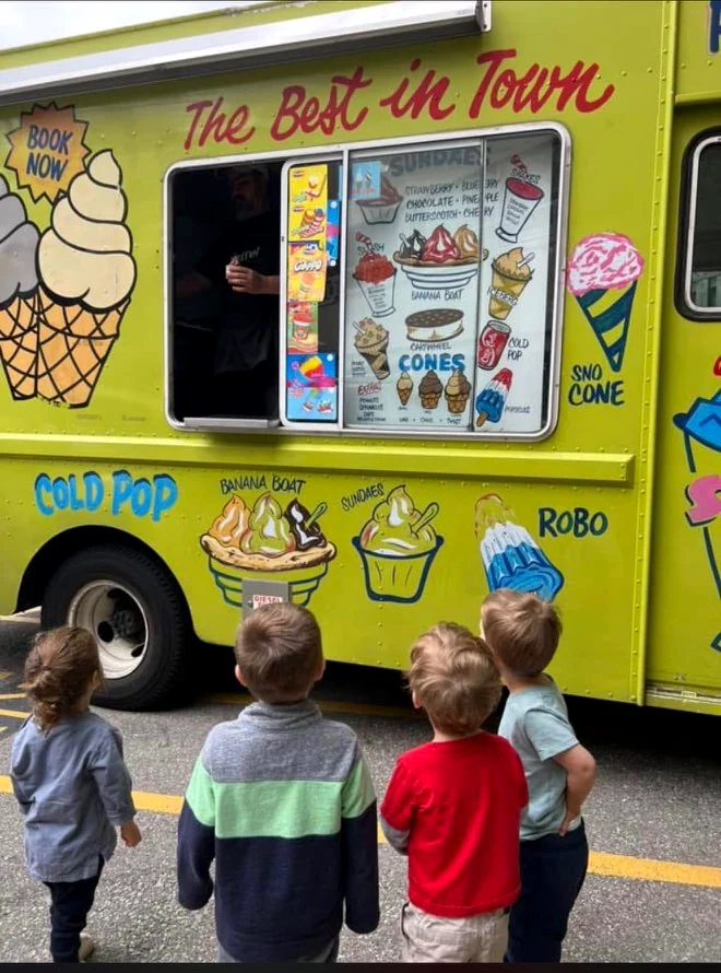 Kids choosing treats at the hand-painted Champion Ice Cream serving window
